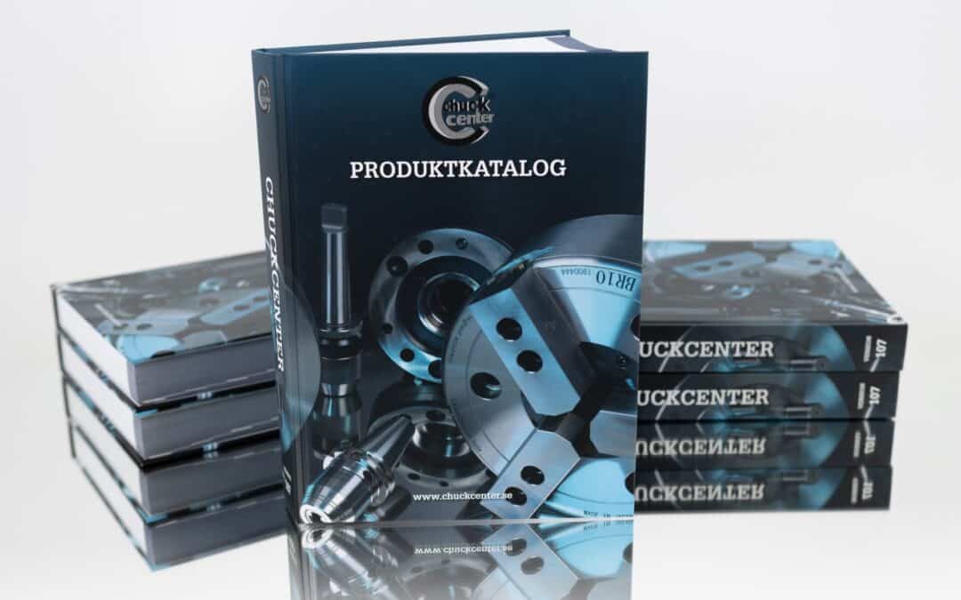 Ett reklamfoto av en produktkatalog för Chuck Center, med en omslagsbild av olika chuckverktyg och utrustning. Flera exemplar är staplade bredvid och bakom huvudkatalogen.